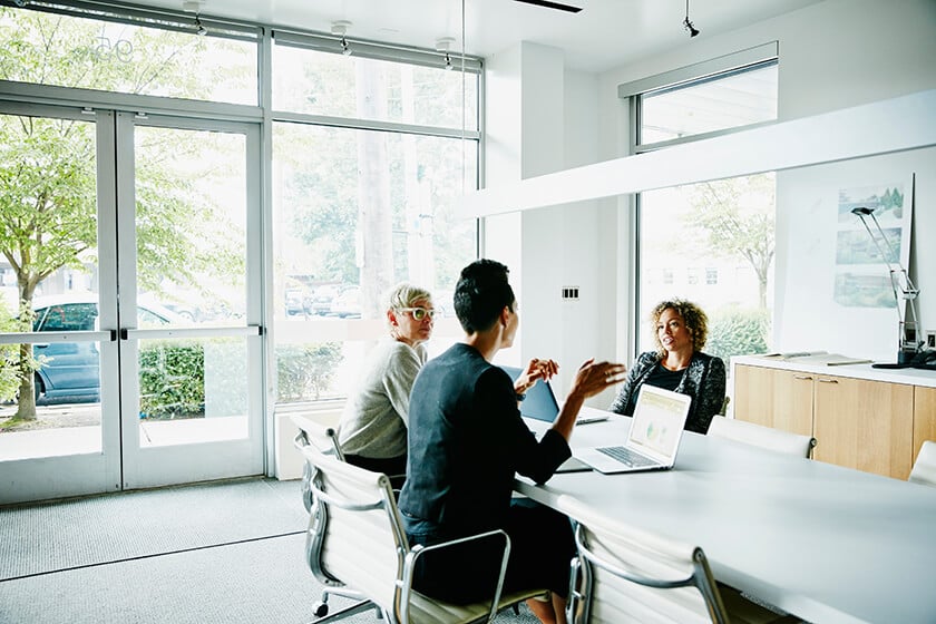 people in office around table talking people in office around table talking